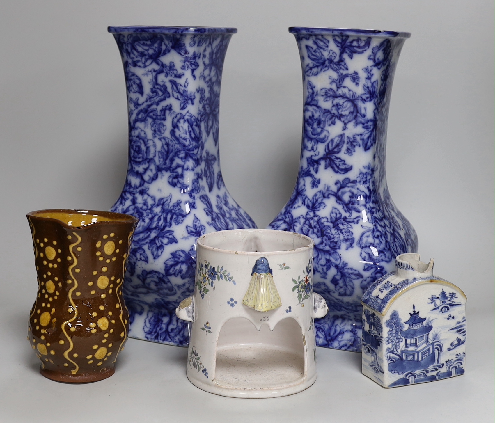 A pair of Losol ware blue and white vases, a slipware jug, a faience candle holder and a Chinese tea canister (without cover), vases 33cm high